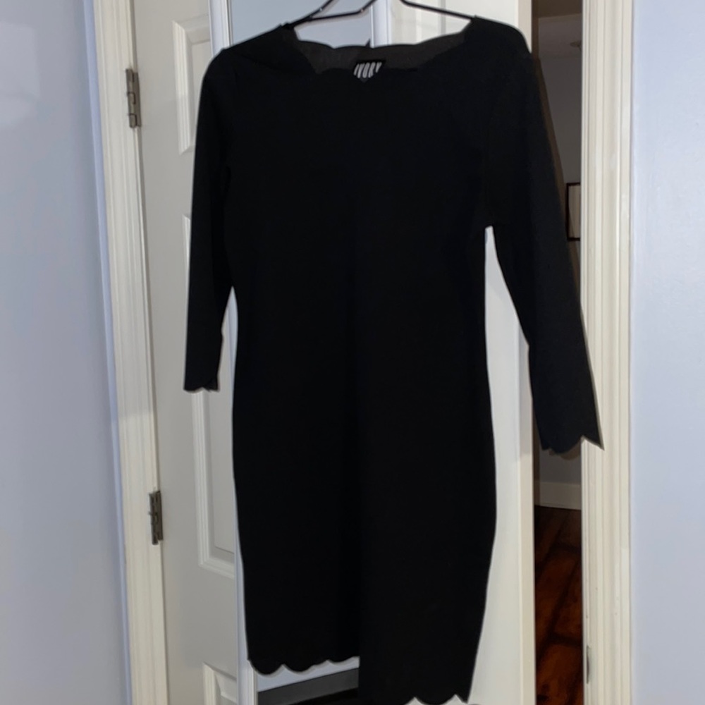 Black form fitting dress with scallop detail